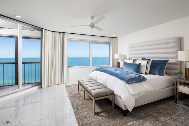 bedroom with ceiling fan, a water view, and access to outside