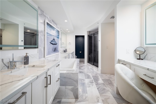 bathroom with vanity and separate shower and tub