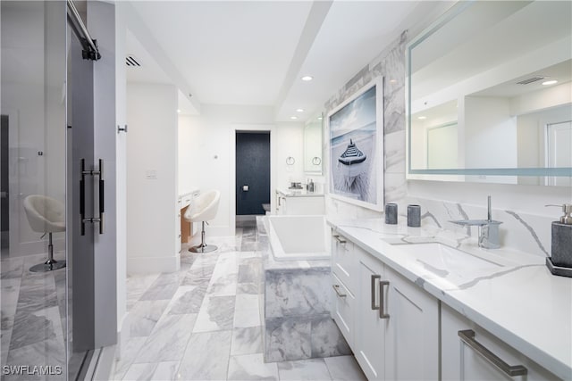 bathroom featuring vanity and a tub