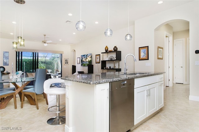 kitchen featuring sink, hanging light fixtures, stainless steel dishwasher, a kitchen island with sink, and white cabinets