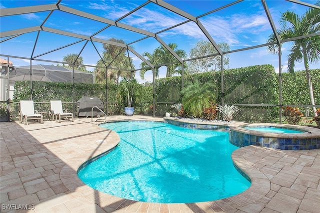 view of pool with a lanai, a patio, and an in ground hot tub