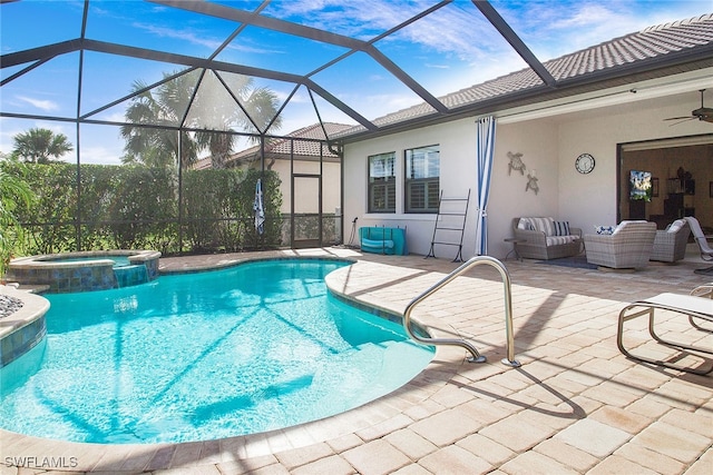 view of swimming pool featuring glass enclosure, ceiling fan, an in ground hot tub, and a patio