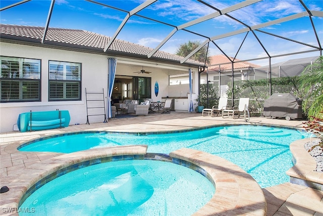 view of swimming pool with a lanai, ceiling fan, a patio area, and an in ground hot tub