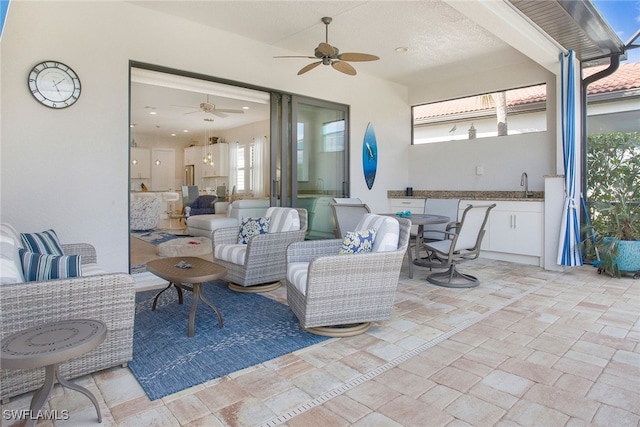 view of patio featuring outdoor lounge area, ceiling fan, and sink