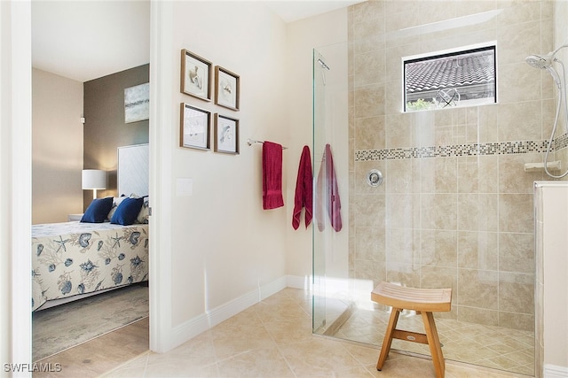 bathroom with tile patterned flooring and a tile shower