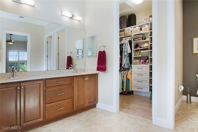 bathroom featuring hardwood / wood-style floors, vanity, and ceiling fan