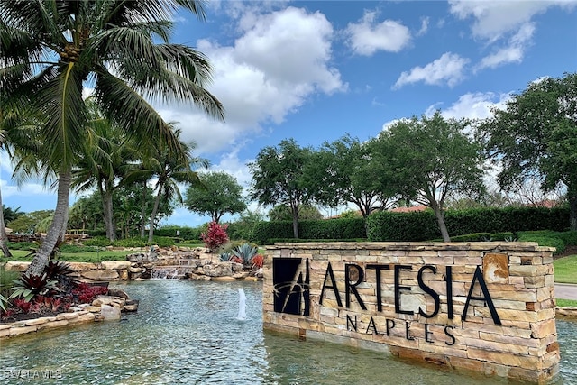 community / neighborhood sign with a water view