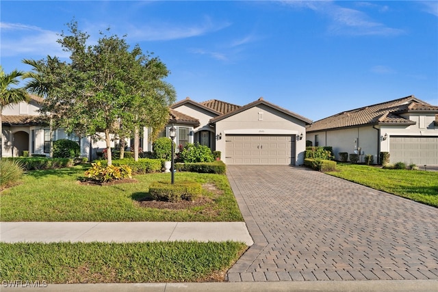 view of front of home with a garage and a front lawn