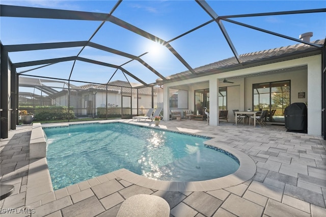 view of pool featuring ceiling fan, a lanai, and a patio