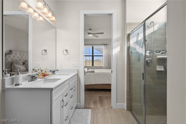 bathroom featuring ceiling fan, walk in shower, and vanity