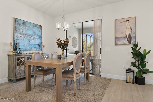 dining area with an inviting chandelier