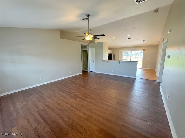 unfurnished living room with ceiling fan, dark hardwood / wood-style flooring, and vaulted ceiling