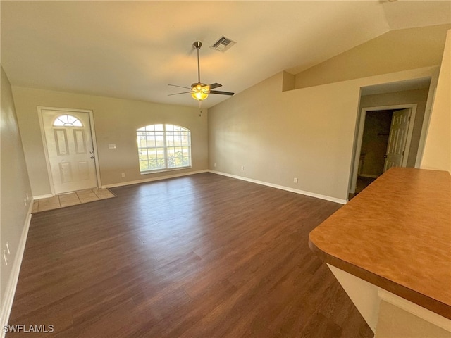 unfurnished living room featuring ceiling fan, dark hardwood / wood-style flooring, and lofted ceiling