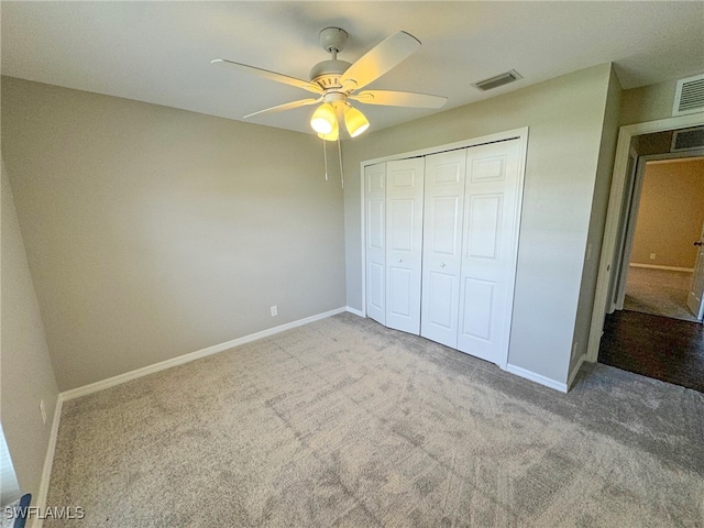 unfurnished bedroom with carpet flooring, a closet, and ceiling fan