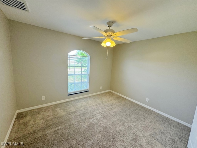 carpeted spare room featuring ceiling fan