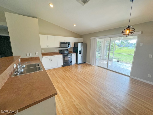 kitchen featuring vaulted ceiling, sink, black appliances, white cabinetry, and hanging light fixtures