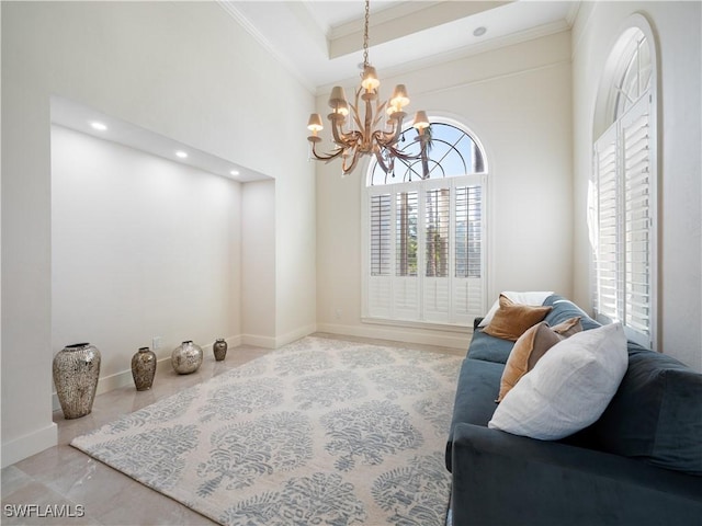 living room featuring a towering ceiling, crown molding, a tray ceiling, and a chandelier