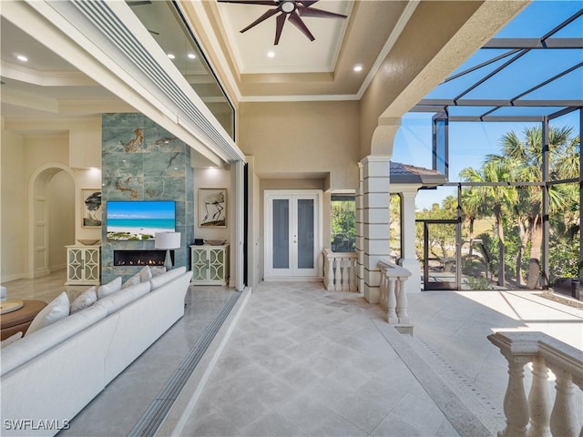 view of patio featuring ceiling fan, a lanai, and french doors