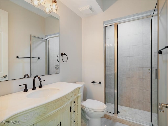 bathroom with vanity, toilet, and a shower with door