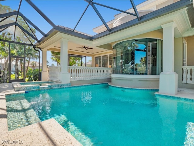 view of pool with ceiling fan, an in ground hot tub, and glass enclosure