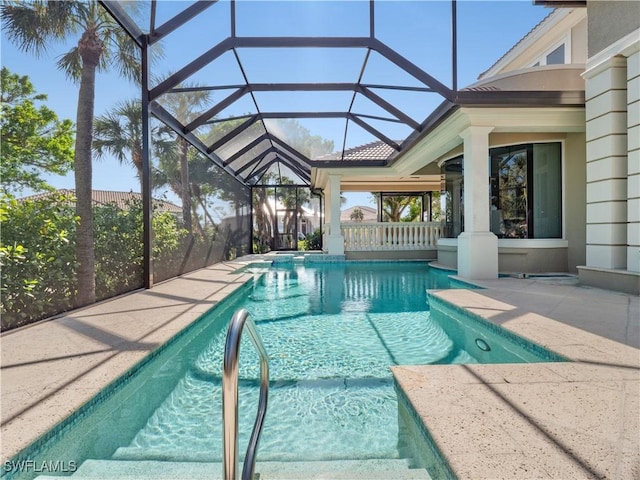 view of swimming pool with a patio area and a lanai