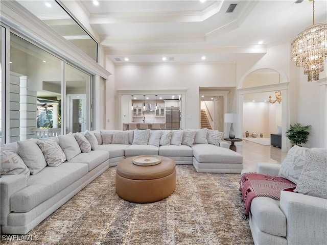 living room with a notable chandelier and crown molding