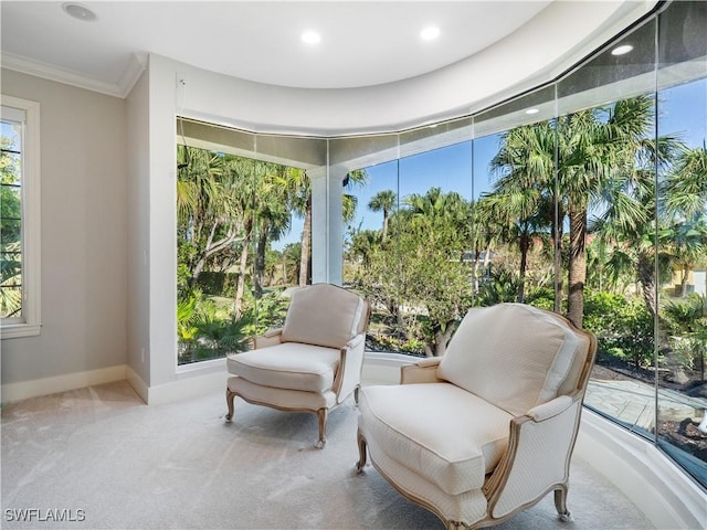 sitting room with light colored carpet and ornamental molding