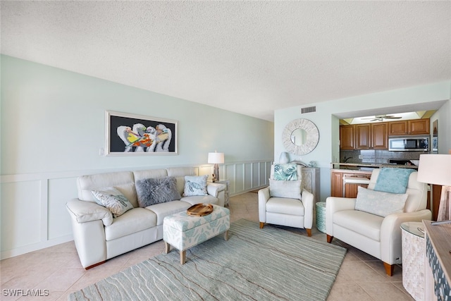 living room featuring light tile patterned flooring and a textured ceiling