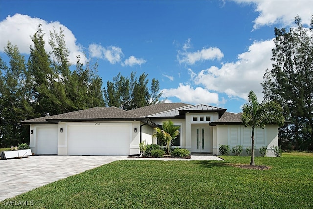 view of front of home featuring a garage and a front lawn