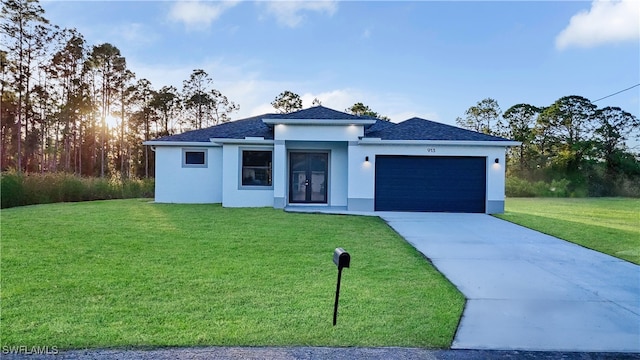 view of front facade with a garage and a yard