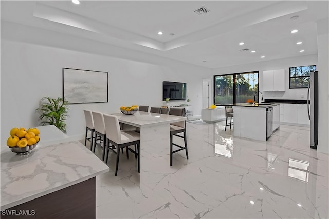 dining space with a tray ceiling