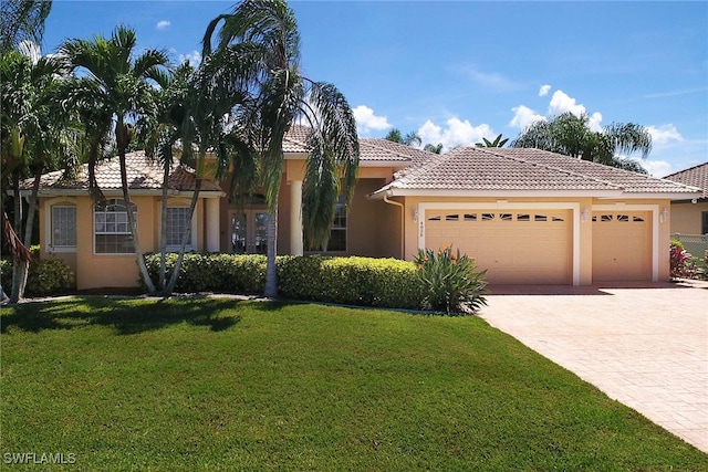 mediterranean / spanish-style house featuring a front lawn and a garage