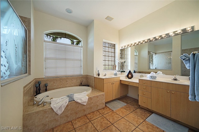 bathroom with shower with separate bathtub, vanity, and tile patterned flooring