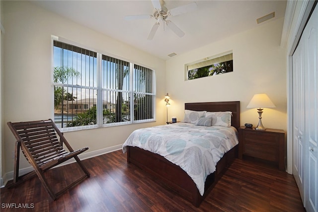 bedroom featuring ceiling fan, a closet, and dark hardwood / wood-style flooring