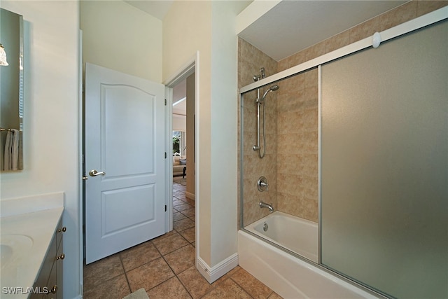 bathroom featuring tile patterned floors, enclosed tub / shower combo, and vanity