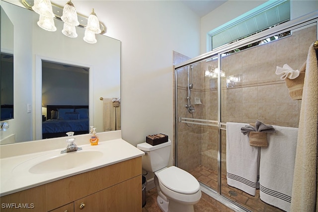 bathroom with toilet, vanity, and an enclosed shower