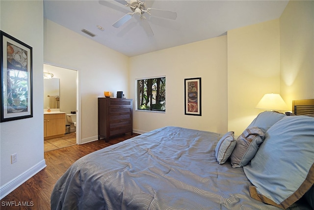 bedroom with ceiling fan, ensuite bathroom, and hardwood / wood-style flooring