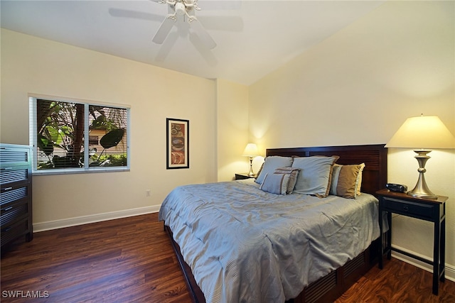 bedroom with dark wood-type flooring, ceiling fan, and vaulted ceiling