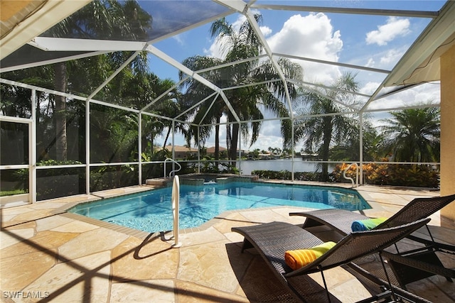 view of pool with a lanai, a water view, and a patio area