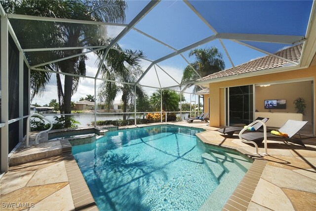 view of pool with a water view, an in ground hot tub, a patio, and a lanai