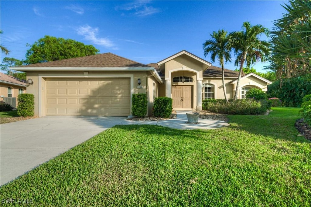 single story home with a garage and a front yard