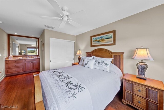 bedroom with dark hardwood / wood-style floors, a closet, and ceiling fan