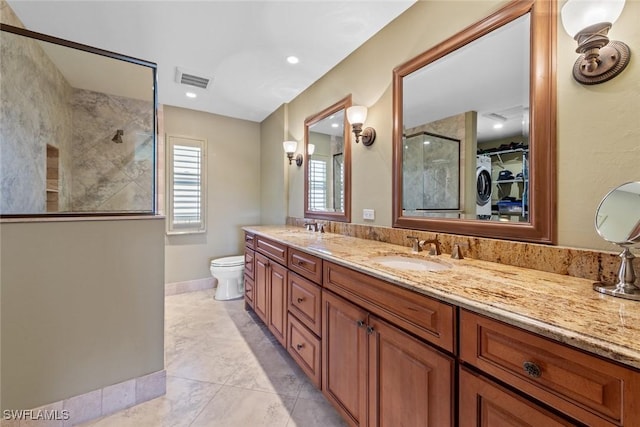 bathroom featuring vanity, toilet, and a shower with shower door