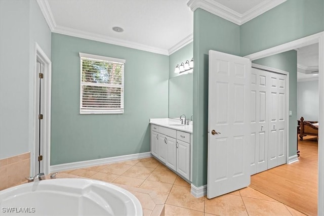 bathroom with vanity, a tub, tile patterned floors, and ornamental molding