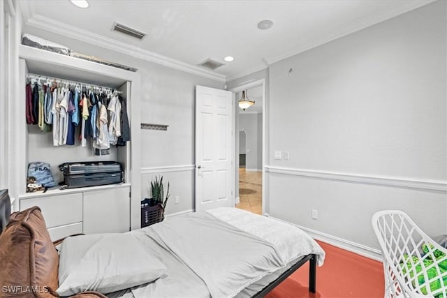 bedroom with a closet and crown molding