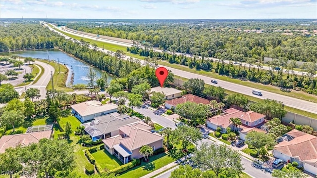 birds eye view of property with a water view