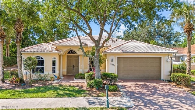 mediterranean / spanish-style home with a garage