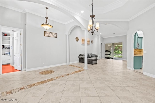 interior space featuring light tile patterned floors, decorative columns, a tray ceiling, a chandelier, and crown molding