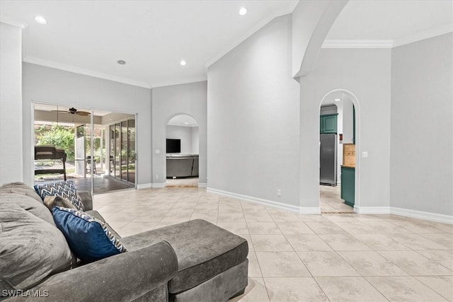 living room with ceiling fan, light tile patterned floors, and crown molding