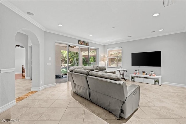 tiled living room with ceiling fan, ornamental molding, and a healthy amount of sunlight